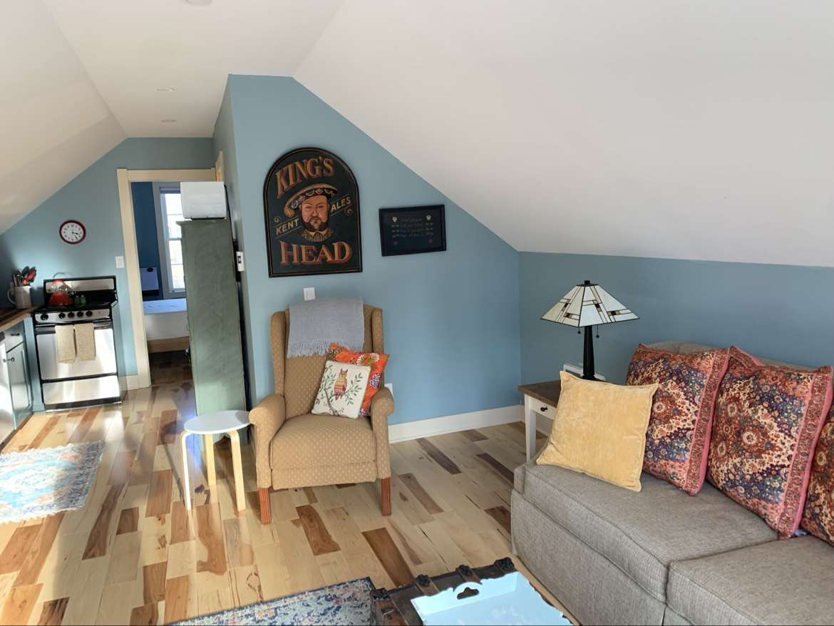 Wide view of the Guest Apartment living room opening into the kitchen