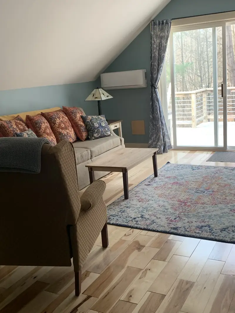 Guest Apartment living room with sliding glass doors opening onto the deck