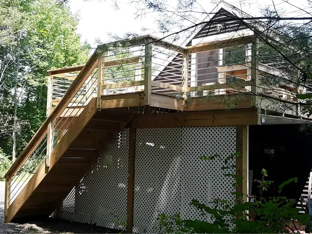 Wooden deck stairs leading up to the Guest Apartment entrance